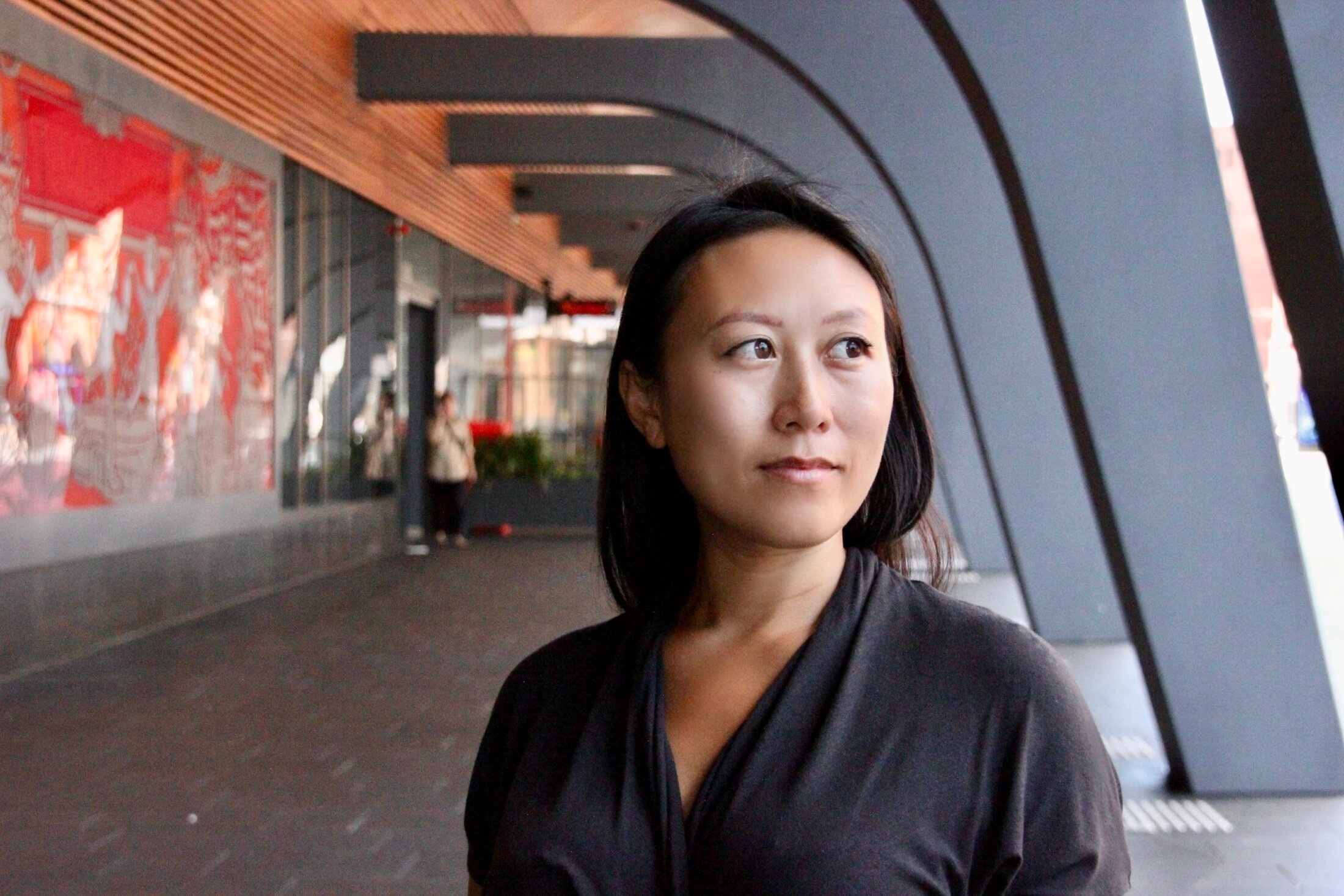 Natasha Fong beneath a curved architectural canopy